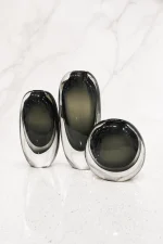 Deep forest green heavy glass vase trio displayed on a modern table