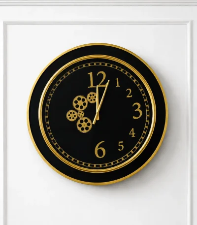 Black and gold luxury wall clock with decorative gear design and modern round frame mounted on a marble-textured wall.