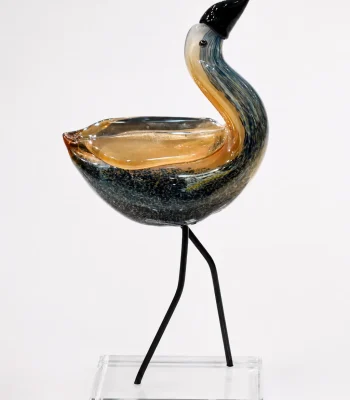 Contemporary hand-blown glass bird figurine with amber and smoky black finish on a crystal base