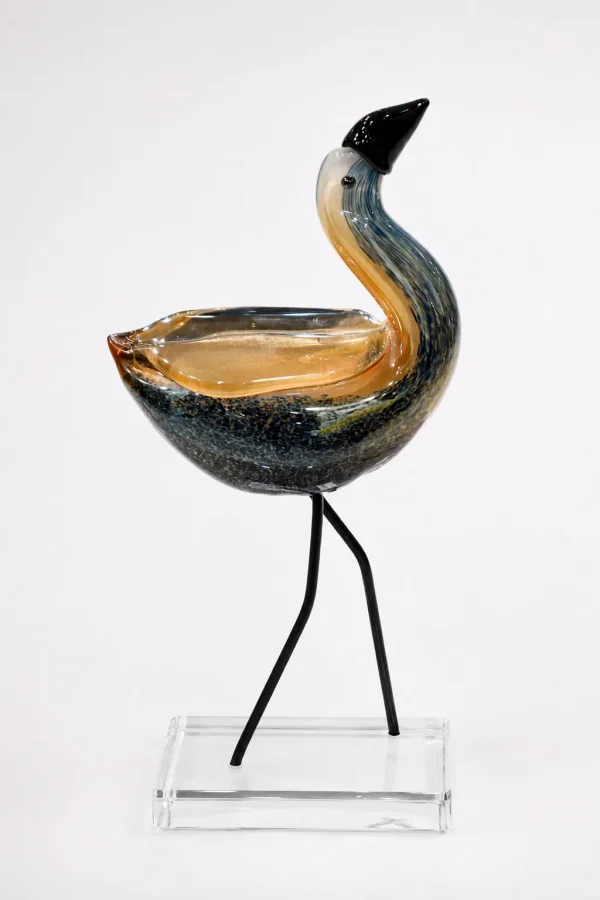 Contemporary hand-blown glass bird figurine with amber and smoky black finish on a crystal base