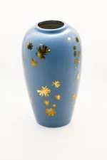 Glossy blue ceramic vase with metallic gold starbursts