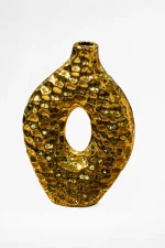 Luxury gold ceramic donut vase with a textured pebble finish and hollow center displayed on a wooden table.