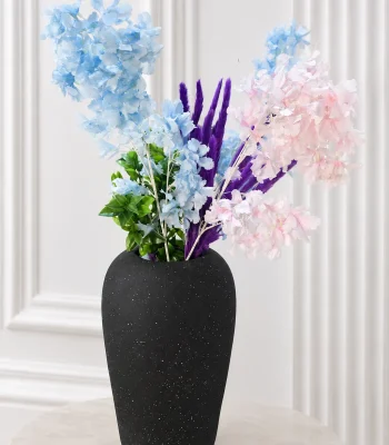 Alt-Text: Textured matte black vase with pastel blue and pink artificial flowers