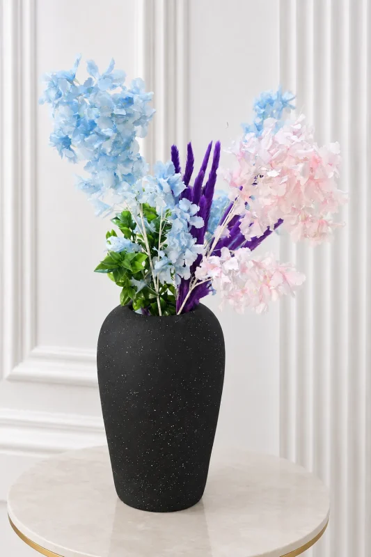 Alt-Text: Textured matte black vase with pastel blue and pink artificial flowers
