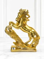 Luxury golden rearing horse decorative showpiece with a textured base for modern home and office décor.