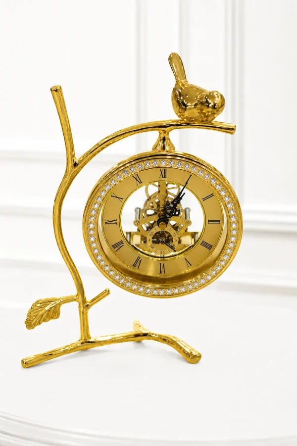 Elegant gold bird table clock on a branch stand with a crystal-rimmed skeleton dial.
