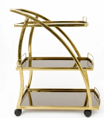 Modern luxury gold 3-tier bar cart with curved metallic supports, dark tinted mirrored shelves, and black rolling caster wheels against a white backdrop.