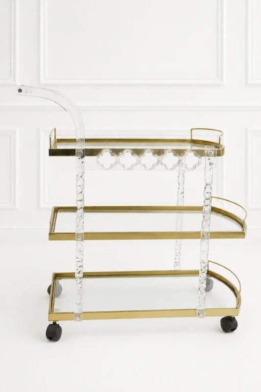 Premium acrylic and gold 3-tier bar cart featuring twisted lucite support pillars, transparent glass shelves, a curved handle, and rolling caster wheels