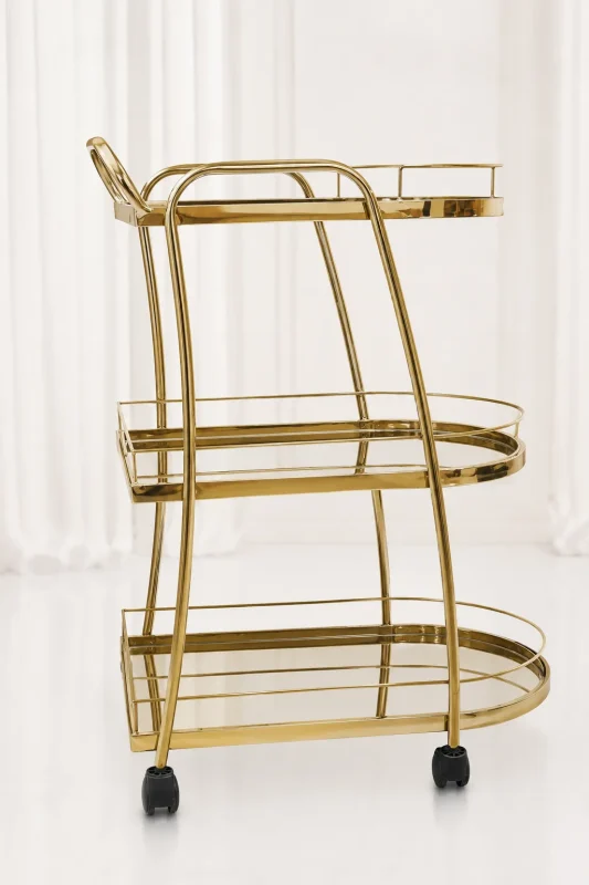 Premium oval gold 3-tier bar cart showcasing an elongated metallic frame, matching gold-mirrored shelves, an integrated push handle, and rolling caster wheels.