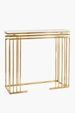 A modern rectangular console table featuring a polished gold metal frame made of vertical rod pillars and a sleek white tabletop, isolated against a white background.