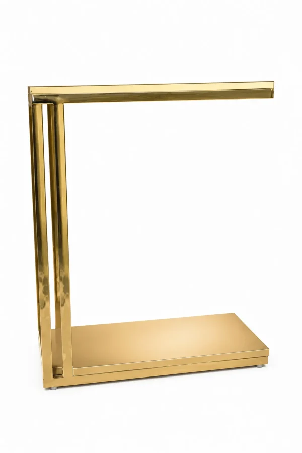 A modern minimalist C-shaped side table crafted entirely from polished gold metal with dual vertical pillars and a rectangular base, isolated against a white background.