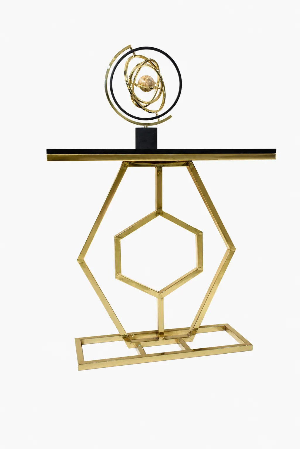 Geometric Gold Console Table with Sleek Black Top – Luxury Hexagon Metal Accent Table for Entryway and Living Room A luxury modern console table featuring a polished gold geometric hexagon metal frame, a sleek black tabletop, and a gold decorative armillary sphere on top, isolated against a white background.