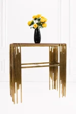 Luxury modern console table featuring a dark wood top and side pillars made of staggered, polished gold vertical metal rods, shown with a flower vase.