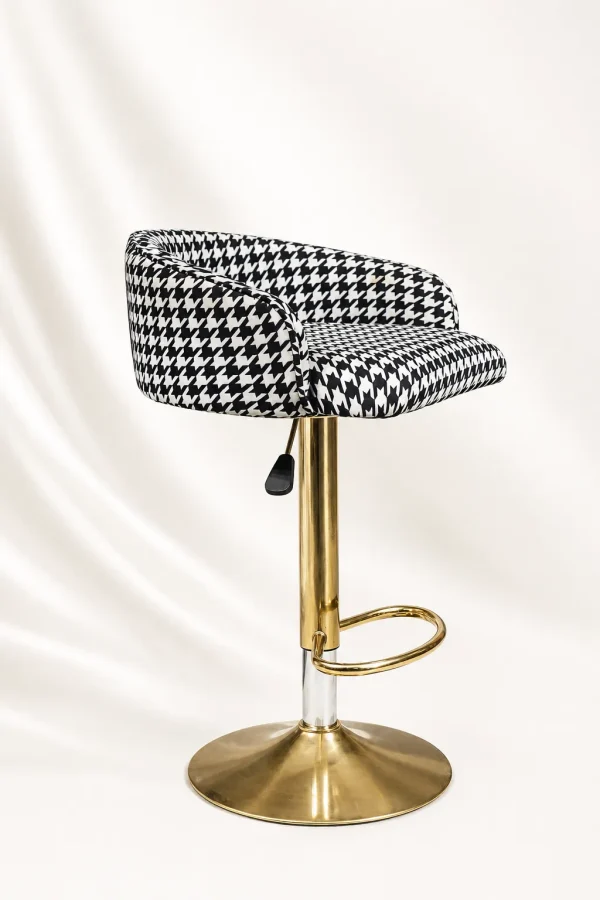 Modern houndstooth gold bar stool from with a black and white patterned swivel cushion seat and a polished metallic gold pedestal base.