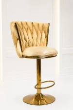 Luxury gold velvet bar stool from featuring a cream tufted woven velvet backrest and a polished metallic gold pedestal base.