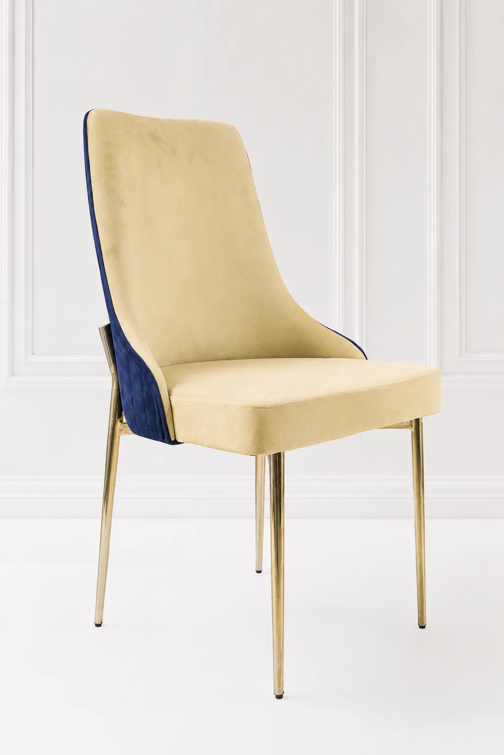 Modern Velvet Dining Chair – Luxury Dual-Tone Beige and Blue Accent Vanity Chair with Gold Legs Modern velvet dining chair from featuring a dual-tone beige and navy blue upholstered seat supported by slim polished gold leg