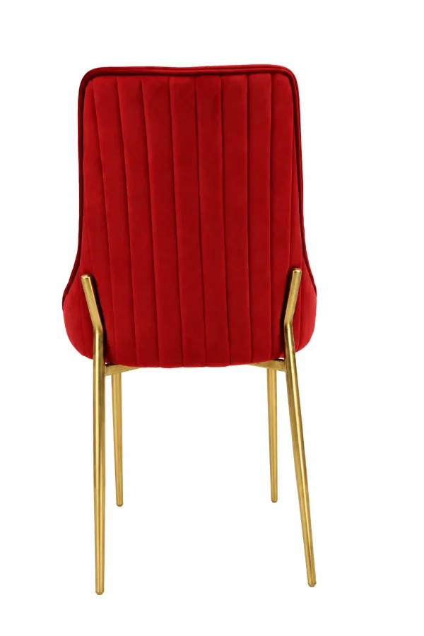 Luxury red velvet dining chair from showing the back view with vertical channel tufting and tapered polished gold metal legs.