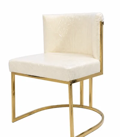 Modern accent chair featuring premium cream upholstered seat and a geometric polished gold metal frame base against a white background.