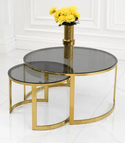 Luxury modern nesting coffee table set featuring round dark smoked glass tops and open crescent polished gold metal frames, displayed against a white background.