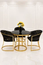 Modern gold round dining table with black velvet chairs
