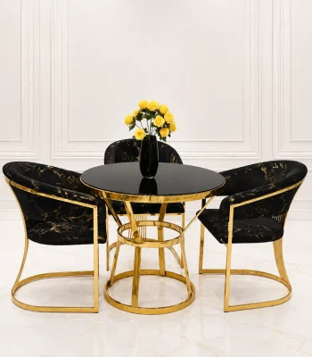 Modern gold round dining table with black velvet chairs