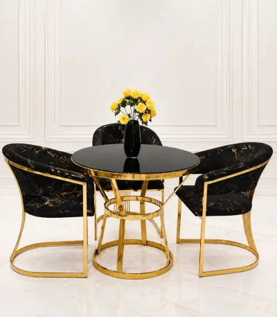 Modern gold round dining table with black velvet chairs