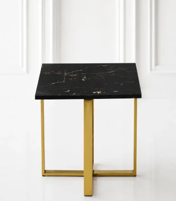 Minimalist square black marble end table showcasing a polished gold stainless steel X-frame base