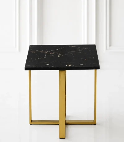 Minimalist square black marble end table showcasing a polished gold stainless steel X-frame base