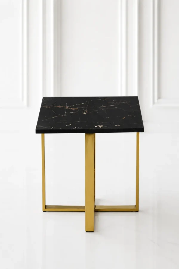 Minimalist square black marble end table showcasing a polished gold stainless steel X-frame base