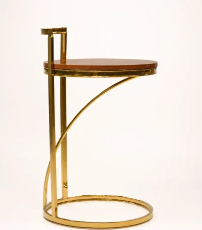 Modern gold C-shaped side table featuring an architectural cantilevered metal frame and a polished round wooden tabletop, isolated against a solid white background.