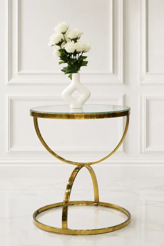 Luxury round glass top side table with gold crescent base featuring a white vase of roses