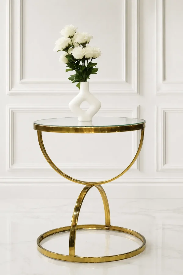 Luxury round glass top side table with gold crescent base featuring a white vase of roses