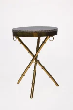 Luxury round granite top side table with gold tripod base featuring textured bamboo-style legs and ring accents
