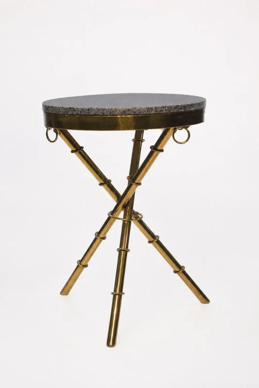 Luxury round granite top side table with gold tripod base featuring textured bamboo-style legs and ring accents