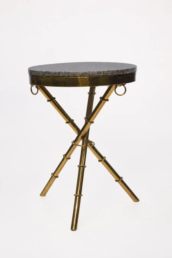 Luxury round granite top side table with gold tripod base featuring textured bamboo-style legs and ring accents