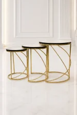 Set of three luxury round marble nesting tables with gold spiral base arranged in a staggered, descending layout