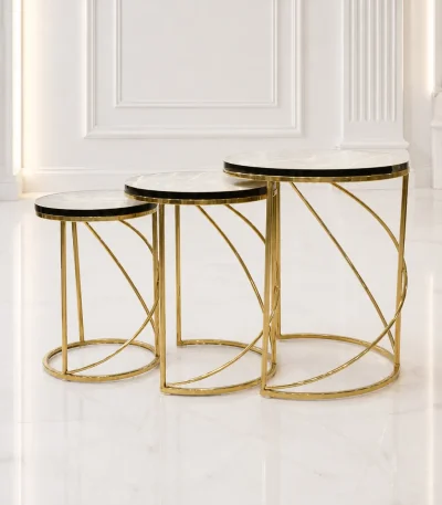 Set of three luxury round marble nesting tables with gold spiral base arranged in a staggered, descending layout