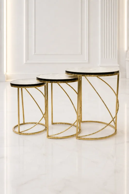 Set of three luxury round marble nesting tables with gold spiral base arranged in a staggered, descending layout