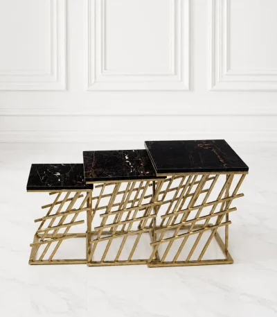 Set of three luxury square black marble nesting tables with gold lattice base arranged in a tiered, descending layout