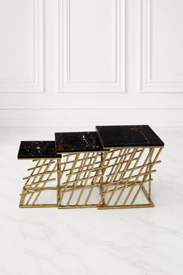 Set of three luxury square black marble nesting tables with gold lattice base arranged in a tiered, descending layout