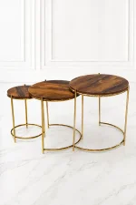 Set of three luxury round rustic wood nesting tables with gold frame arranged in a staggered, descending layout