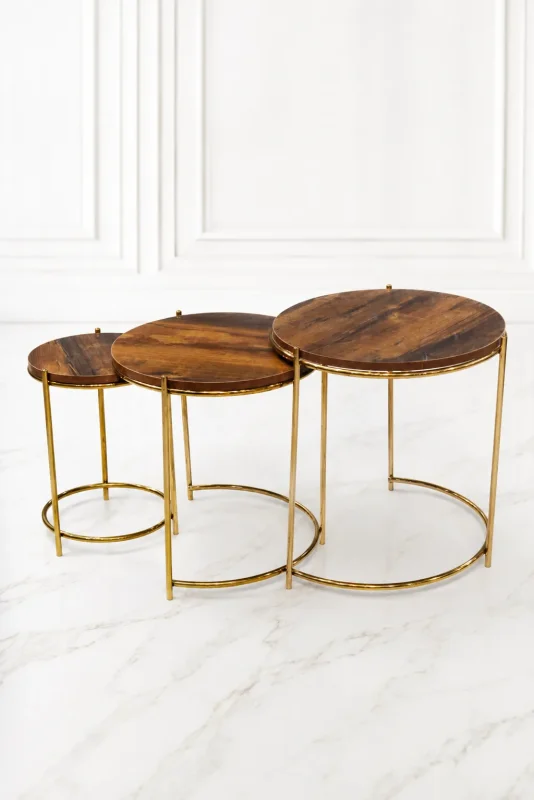 Set of three luxury round rustic wood nesting tables with gold frame arranged in a staggered, descending layout