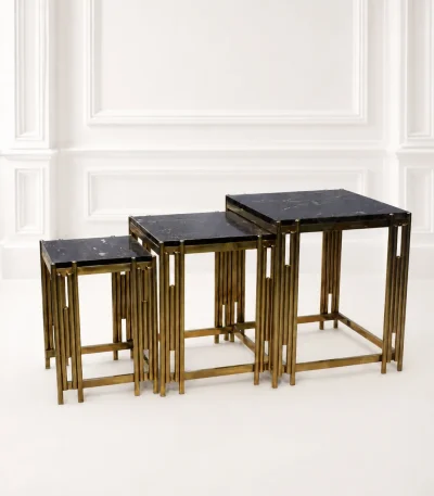 Set of three luxury square black marble nesting tables with gold reeded legs arranged in a tiered, descending layout