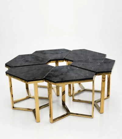 Six luxury hexagonal black marble side tables with gold frames arranged together to form a large modular honeycomb coffee table layout