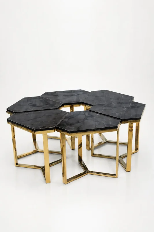 Six luxury hexagonal black marble side tables with gold frames arranged together to form a large modular honeycomb coffee table layout