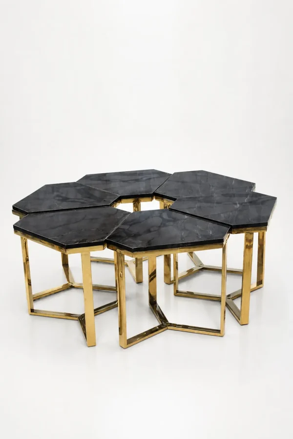 Six luxury hexagonal black marble side tables with gold frames arranged together to form a large modular honeycomb coffee table layout