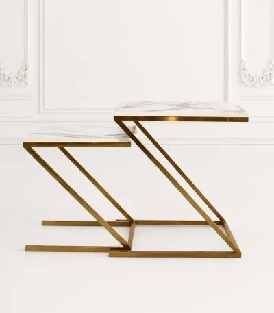 Set of two luxury square white marble nesting tables with gold z base arranged in a nested, staggered layout