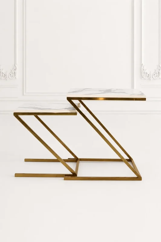 Set of two luxury square white marble nesting tables with gold z base arranged in a nested, staggered layout