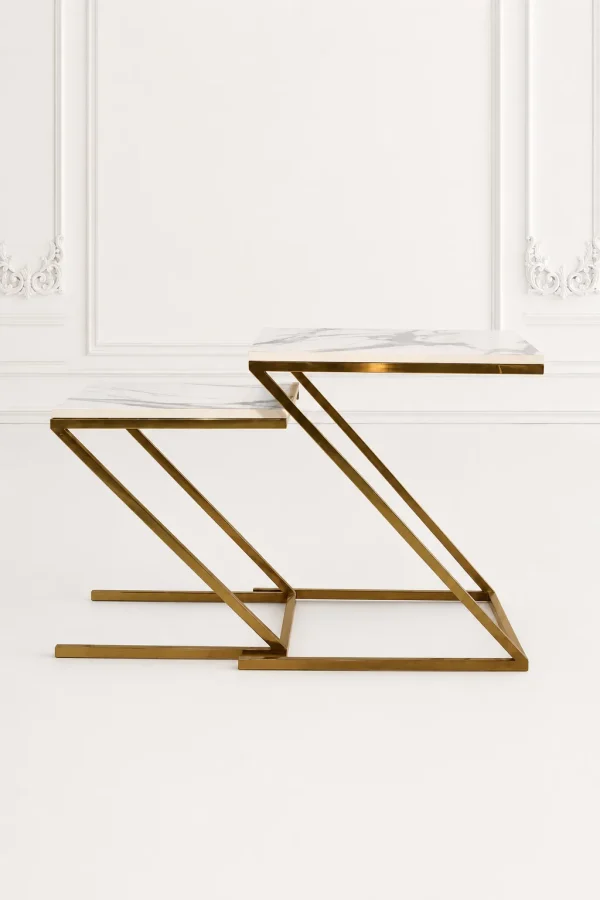 Set of two luxury square white marble nesting tables with gold z base arranged in a nested, staggered layout