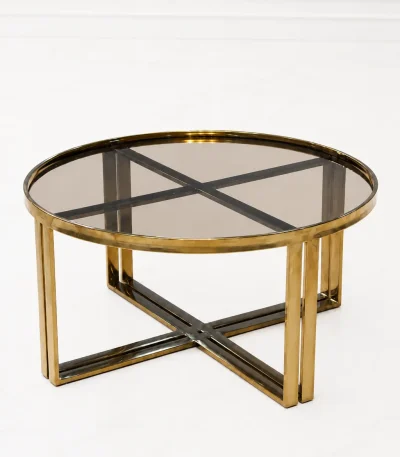 Luxury round smoked glass coffee table with gold x base featuring a translucent tinted glass top and dual-pillar metal legs